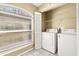 Laundry room with washer, dryer, and window at 14625 Par Club Cir, Tampa, FL 33618