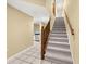 Carpeted stairs with wooden railings leading upstairs at 14625 Par Club Cir, Tampa, FL 33618