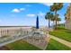 Beachfront access with white sand beach and patio furniture at 17960 Gulf Blvd # 115, Redington Shores, FL 33708