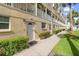 Condo building exterior showcasing walkway and landscaping at 17960 Gulf Blvd # 115, Redington Shores, FL 33708