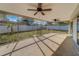 Bright screened porch with ceiling fans, overlooking backyard at 1803 Southwood Ln, Clearwater, FL 33764