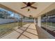 Bright screened porch with ceiling fans, overlooking backyard at 1803 Southwood Ln, Clearwater, FL 33764