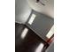 Bright bedroom with dark hardwood floors and two windows at 18229 Port Side St, Tampa, FL 33647