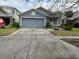 Gray house with a two-car garage and a well-maintained lawn at 18229 Port Side St, Tampa, FL 33647