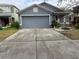 Gray house with a two-car garage and a well-maintained lawn at 18229 Port Side St, Tampa, FL 33647