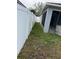 Side yard with grassy area and privacy fence at 18229 Port Side St, Tampa, FL 33647