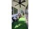 Relaxing screened porch with wicker furniture and artificial turf at 2348 Shelley St # 4, Clearwater, FL 33765
