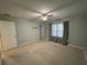 Spacious bedroom with a ceiling fan and neutral carpet flooring at 2409 Hearth Dr, Odessa, FL 33556