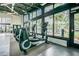 Fitness center with modern cardio equipment overlooking the pool and lush landscaping at 2409 Hearth Dr, Odessa, FL 33556