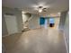 Open concept living room with staircase and kitchen with island at 2409 Hearth Dr, Odessa, FL 33556