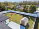Aerial view of a backyard with a shed and a white fence at 26728 Hickory Loop, Lutz, FL 33559