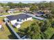 Aerial view of a house and backyard with a shed and a white fence at 26728 Hickory Loop, Lutz, FL 33559