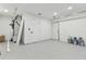 Unfinished basement area with high ceilings and a garage door at 26728 Hickory Loop, Lutz, FL 33559