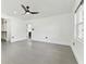 Bright bedroom with grey tile floors and a ceiling fan at 26728 Hickory Loop, Lutz, FL 33559