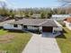 Modern home exterior with a new roof and landscaping at 26728 Hickory Loop, Lutz, FL 33559