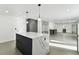 Open concept kitchen with marble island and views into living area at 26728 Hickory Loop, Lutz, FL 33559