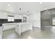 Modern kitchen with white cabinets, marble island, and stainless steel appliances at 26728 Hickory Loop, Lutz, FL 33559