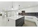 Modern kitchen with white cabinets, marble island, and stainless steel appliances at 26728 Hickory Loop, Lutz, FL 33559
