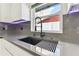 Modern kitchen sink with black faucet and sleek grey countertop at 26728 Hickory Loop, Lutz, FL 33559