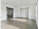 Open living room with grey tile floors and glass doors at 26728 Hickory Loop, Lutz, FL 33559