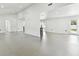 Open living area with gray tile floors and access to backyard at 26728 Hickory Loop, Lutz, FL 33559