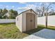 Tan colored storage shed in backyard at 26728 Hickory Loop, Lutz, FL 33559