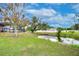 Beautiful backyard featuring a tranquil pond, verdant lawn, and screened-in patio perfect for outdoor living at 3406 Ranchdale Dr, Plant City, FL 33566
