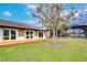 Backyard with multiple French doors leading to patio, screened lanai, and beautiful views at 3406 Ranchdale Dr, Plant City, FL 33566