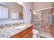 Bathroom vanity with granite countertop and glass-enclosed shower at 3406 Ranchdale Dr, Plant City, FL 33566