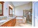 Bathroom featuring a double vanity with granite countertops, a soaking tub, and a glass shower at 3406 Ranchdale Dr, Plant City, FL 33566