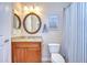 Bathroom featuring granite countertop, wooden cabinets, and vanity mirror at 3406 Ranchdale Dr, Plant City, FL 33566