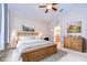 Serene bedroom featuring a wood frame bed, soft lighting, and elegant decor, creating a relaxing retreat at 3406 Ranchdale Dr, Plant City, FL 33566