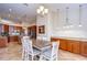 Bright dining area featuring a chandelier, lots of cabinets, and an open floor plan to the kitchen at 3406 Ranchdale Dr, Plant City, FL 33566