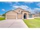 Charming home featuring a three-car garage, manicured lawn, and beautiful landscaping at 3406 Ranchdale Dr, Plant City, FL 33566