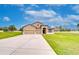 Charming stucco two-story home with three-car garage, manicured lawn, and extended driveway at 3406 Ranchdale Dr, Plant City, FL 33566
