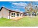 Back exterior shows patio, enclosed pool, and yard with mature tree at 3406 Ranchdale Dr, Plant City, FL 33566