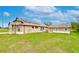 Exterior elevation reveals solar panels, attached and detached garages, and spacious yard at 3406 Ranchdale Dr, Plant City, FL 33566