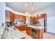 Modern kitchen with granite countertops, stainless steel appliances, a built-in wine cooler, and ample storage at 3406 Ranchdale Dr, Plant City, FL 33566