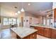 Open kitchen with an island, granite countertops, stainless steel appliances, and an adjacent dining area at 3406 Ranchdale Dr, Plant City, FL 33566