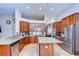 Well-equipped kitchen featuring stainless steel appliances, granite countertops, and a functional center island at 3406 Ranchdale Dr, Plant City, FL 33566