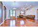 Bright living room featuring hardwood floors, two couches, and large windows at 3406 Ranchdale Dr, Plant City, FL 33566