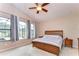The primary bedroom features a vaulted ceiling, carpet, and a view of the screened in patio at 3406 Ranchdale Dr, Plant City, FL 33566