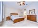 The primary bedroom has wood furniture, carpet flooring, and flows into the primary bathroom at 3406 Ranchdale Dr, Plant City, FL 33566