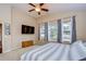 The spacious primary bedroom features carpet flooring and sliding windows with a view of the pool at 3406 Ranchdale Dr, Plant City, FL 33566