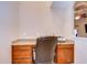 Built-in desk in home office featuring granite countertop and wood cabinets at 3406 Ranchdale Dr, Plant City, FL 33566