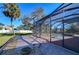 Outdoor pool and patio with a screened-in enclosure and well manicured lawn at 3406 Ranchdale Dr, Plant City, FL 33566