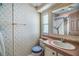 Bathroom with floral wallpaper, vanity sink, decorative curtain, and unique accents at 35934 Verano Ln, Zephyrhills, FL 33541