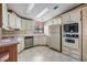Efficient kitchen with white cabinets, stainless steel appliances, and ample counter space at 35934 Verano Ln, Zephyrhills, FL 33541