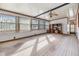 Sun-filled living room with large windows, carpet flooring, and shelving with media storage at 35934 Verano Ln, Zephyrhills, FL 33541