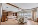 Bright living room featuring hardwood floors, large windows, built-in shelving, and comfortable seating at 35934 Verano Ln, Zephyrhills, FL 33541